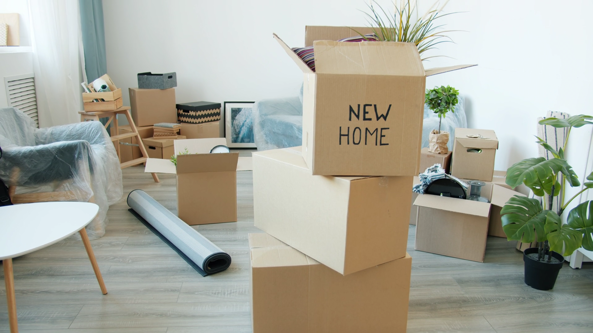 Moving boxes with new home sign